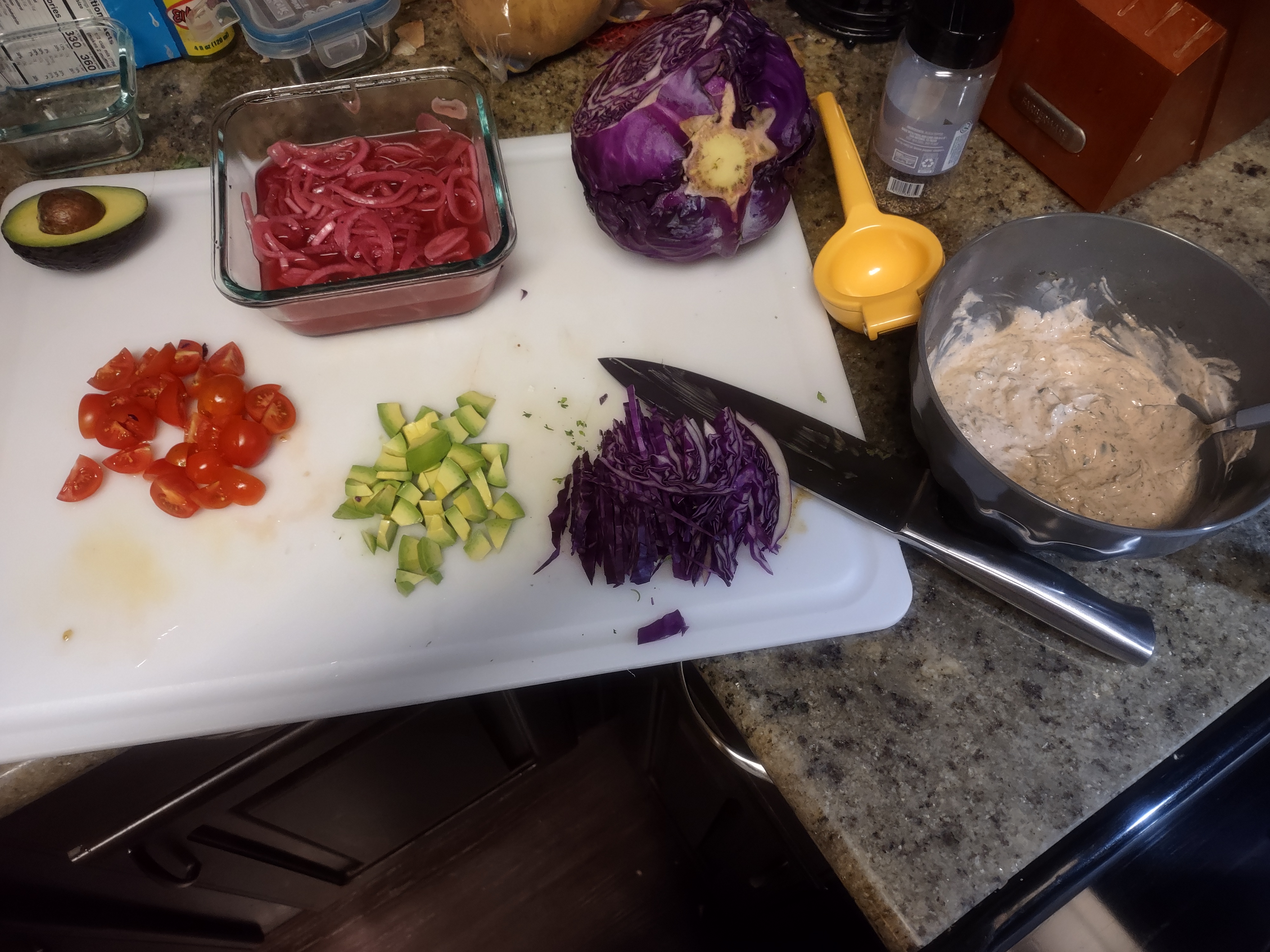 photo of diced cherry tomatoes, avocado, sliced red cabbage, picked onion, and a cilantro lime crema made with greek yogurt