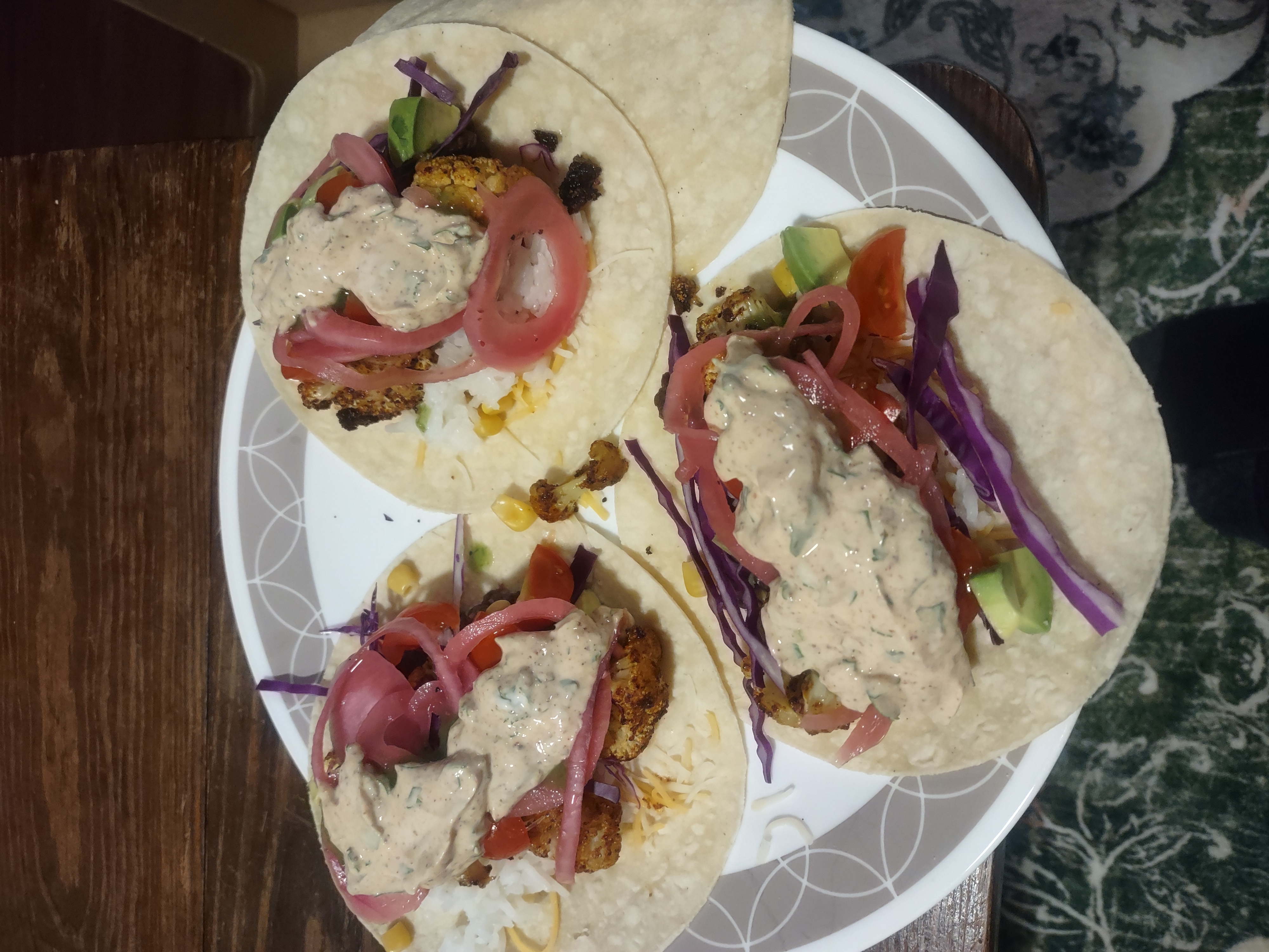 three assembled tacos on corn tortillas with an extra tortilla for any toppings that fall off the taco